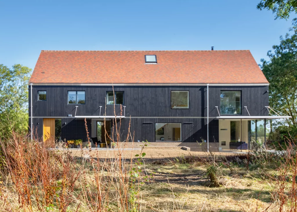 contemporary farmhouse-style build with blackened timber cladding