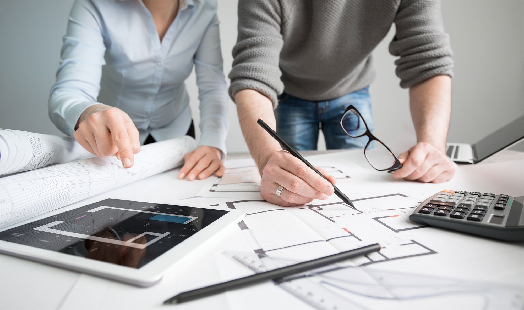 Man and woman looking at house plans and making calculations