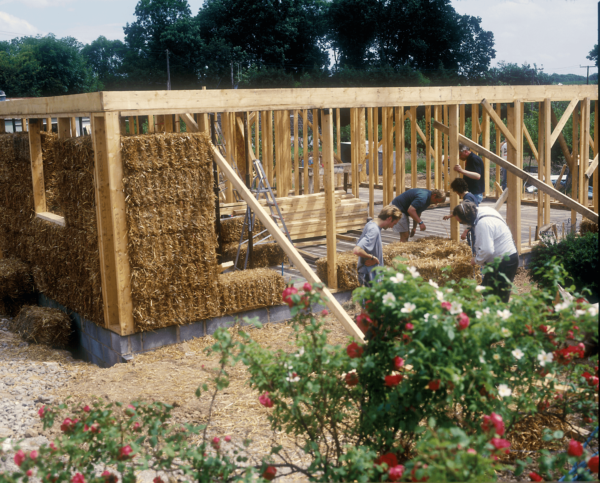 People building with straw bale