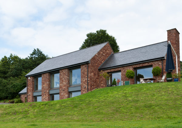 Contemporary timber frame home with stone walls