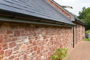 Contemporary timber frame home with stone walls