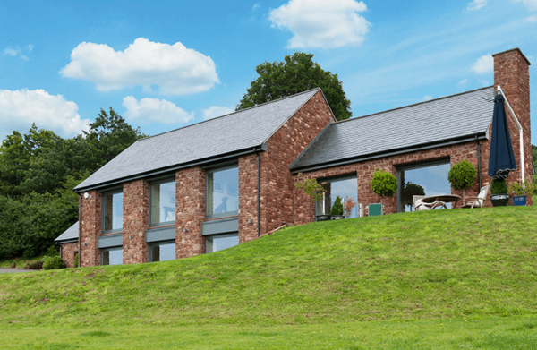 Light filled stone and glass clad house