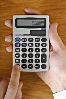 Close-up of hand holding a calculator