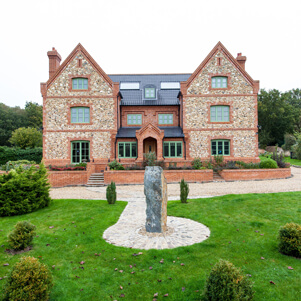 masonry house withe green window frames