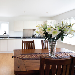 modern kitchen with vase of flowers