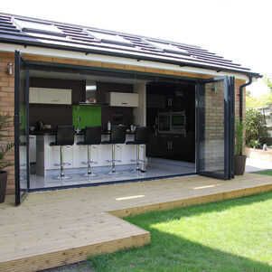 glazed doors opening onto decking and lawn