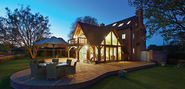 modern oak frame house at night