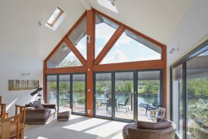 Glass extension with pitched roof and fitted blinds