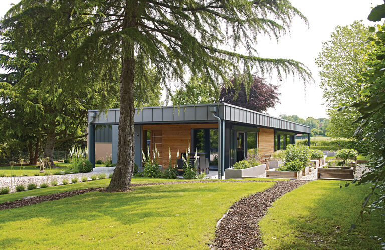 contemporary timber clad house with zinc flat roof