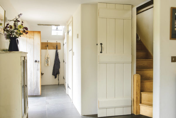 country style hallway with hidden staircase