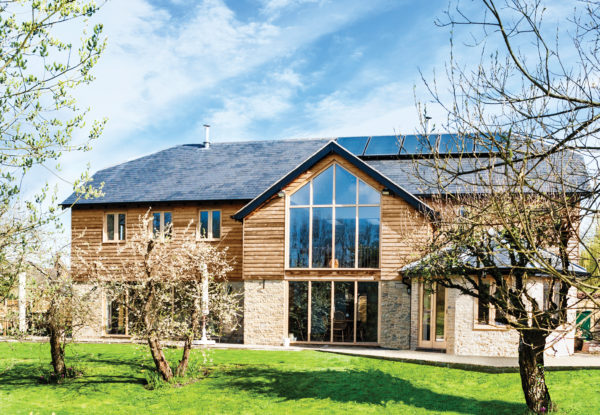 Contemporary barn clad with stone and ThermoWood