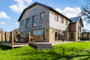 Contemporary barn clad with stone and ThermoWood