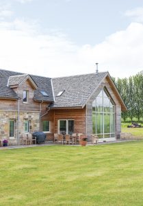 Timber frame sandstone and larch clad home