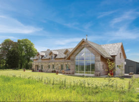 Timber frame sandstone and larch clad home