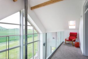 Timber frame sandstone and larch clad home