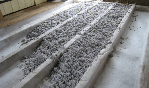 Cellulose insulation laid on a membrane between the joists of a suspended timber floor