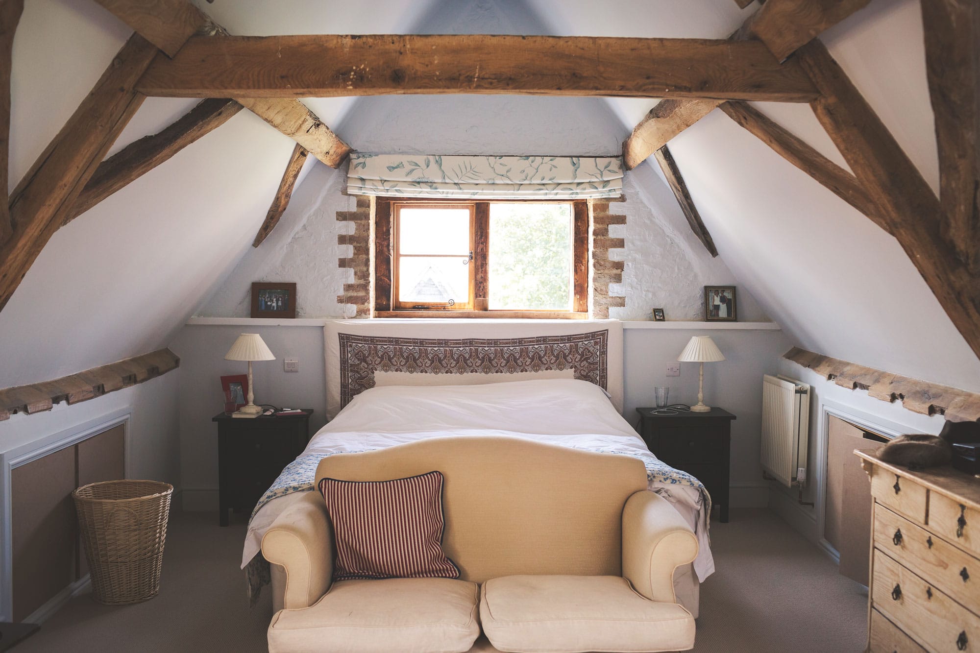 Bedroom in barn conversion with beams