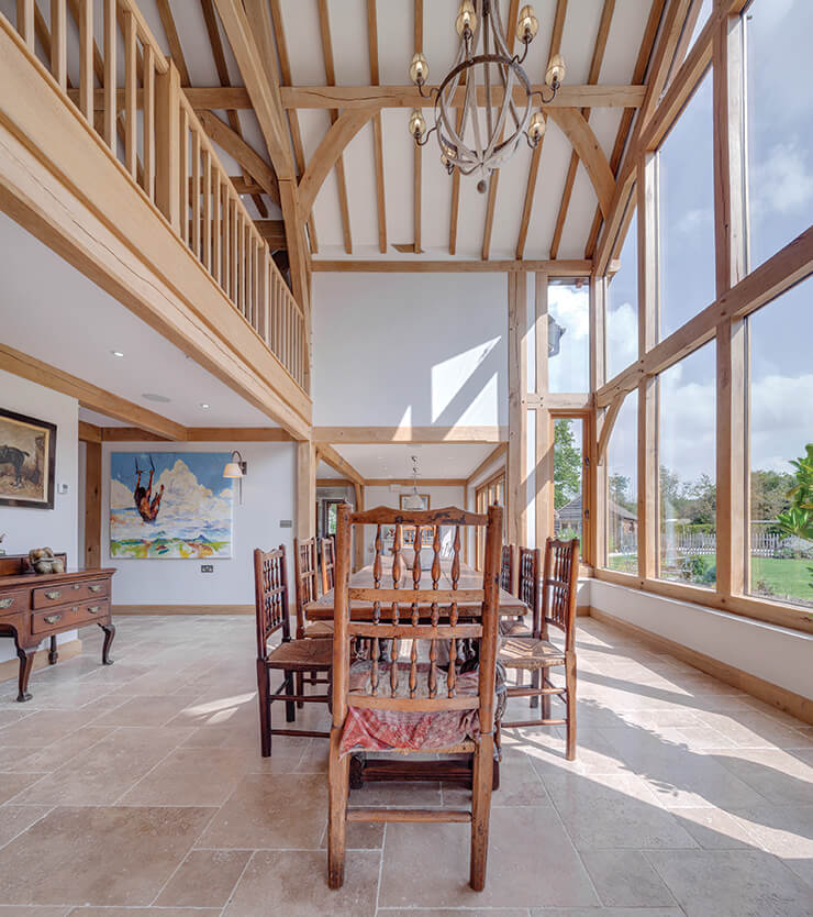 double-height green oak frame dining area