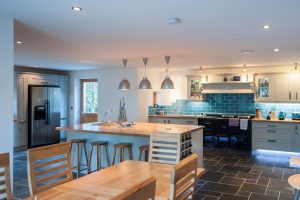 Bright kitchen area with black stone floor