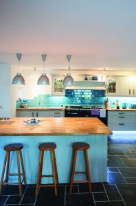 Bright kitchen area with black stone floor