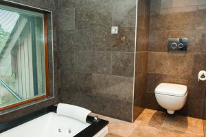 Simple bathroom with dark stone tiles