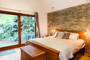 Bright master bedroom with wooden fittings
