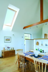 Open plan kitchen and living area with oak beams