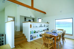 Open plan kitchen and living area with oak beams