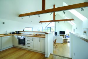 Open plan kitchen and living area with oak beams