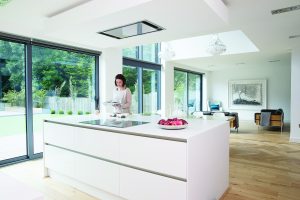 Large white kitchen island with hob