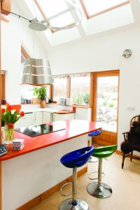 Orange breakfast bar with colourful seating