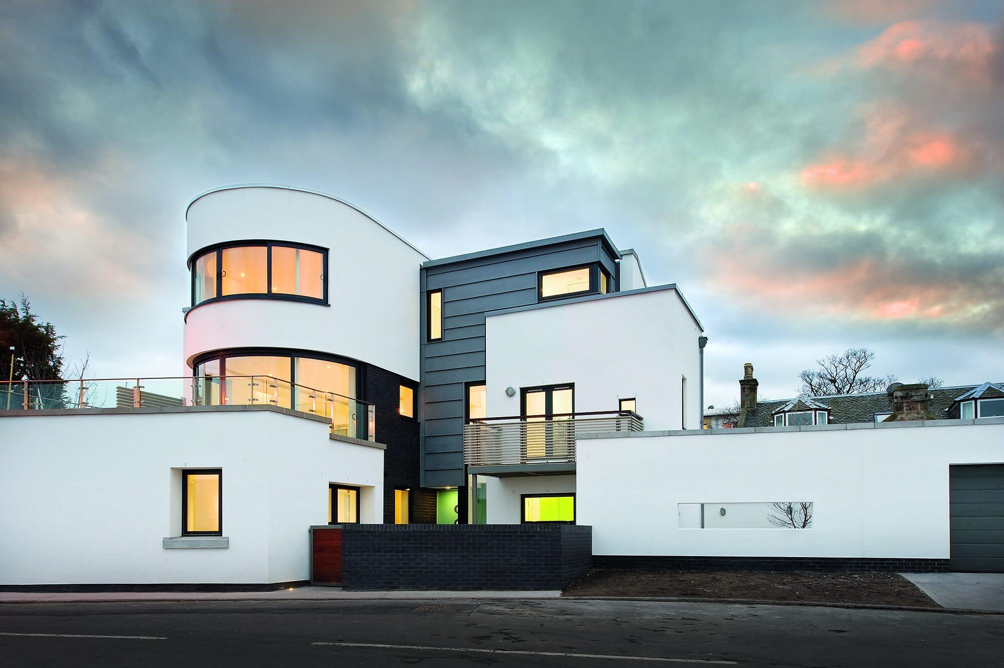 Art deco coastal home with white render and zinc cladding