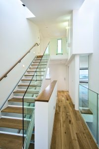 Wooden staircase with glass railing