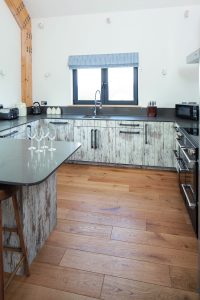Open plan kitchen with wooden floor