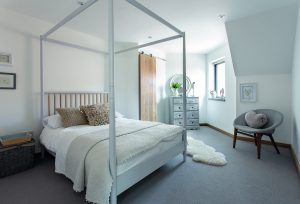 large white bedroom with four poster bed