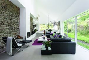 Large white living room with black furniture