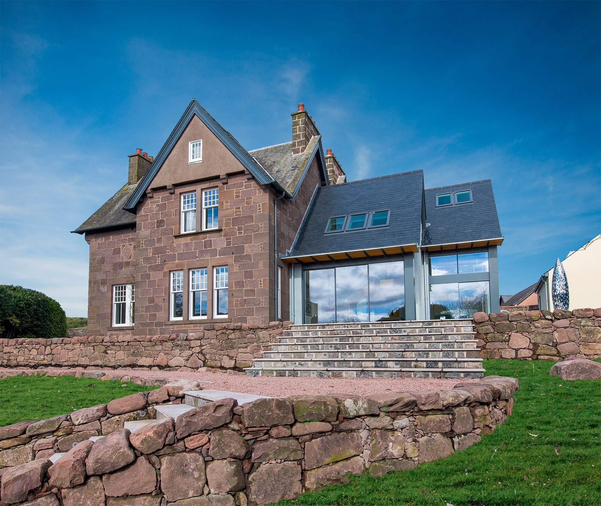 Traditional home with zinc-clad extension