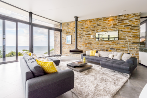 Living room with structural glazing and brick wall with a modern stove