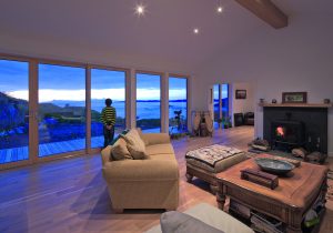 Open plan living room with large windows