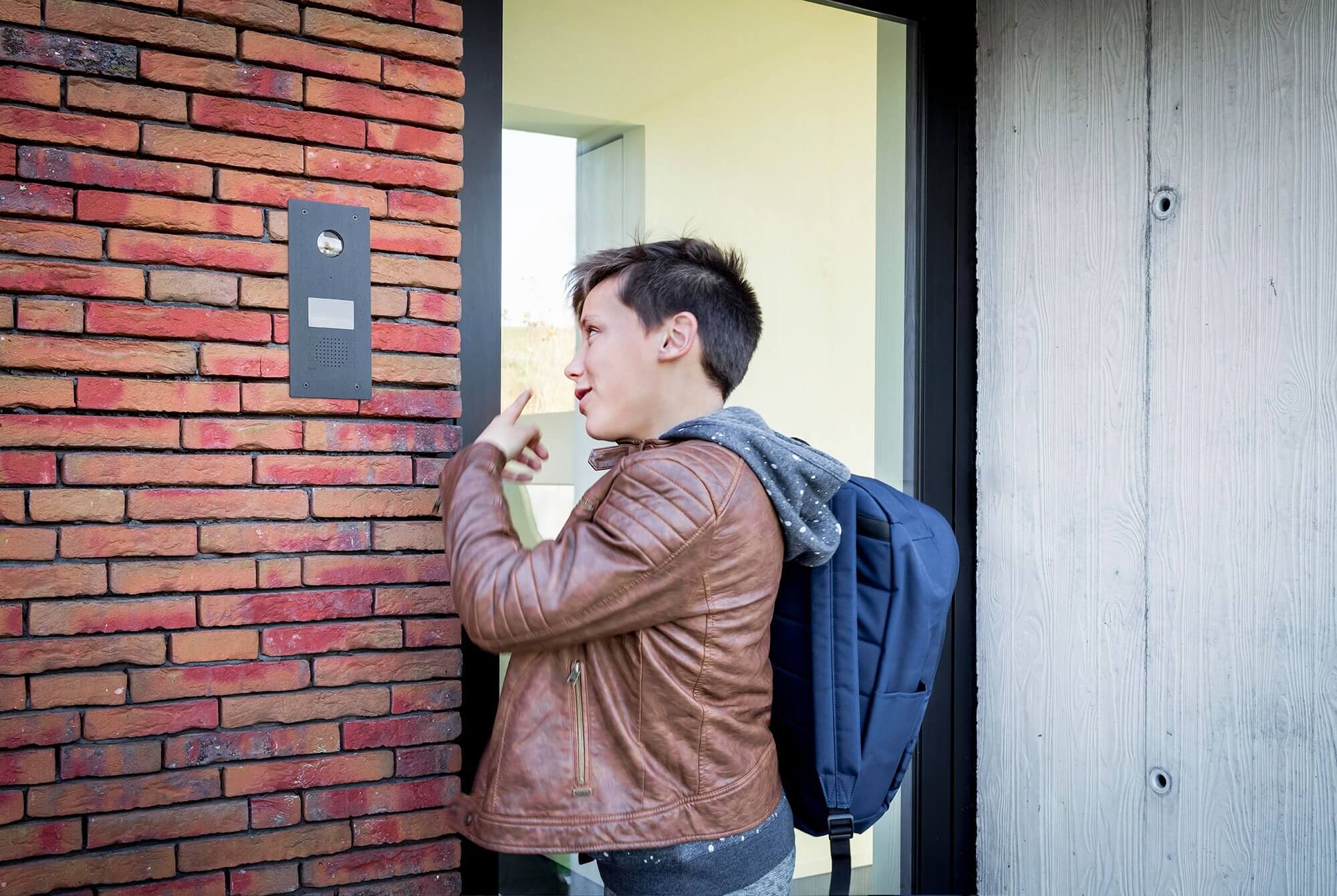 Boy ringing the doorbell