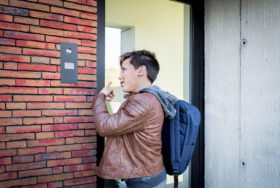 Boy ringing the doorbell