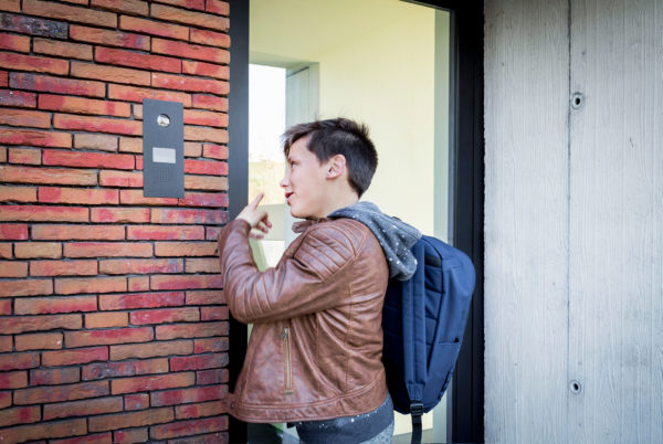 Boy ringing the doorbell