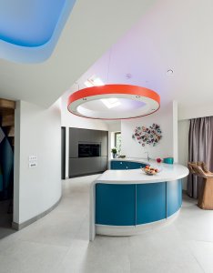 Curved kitchen counter with circular overhead lighting