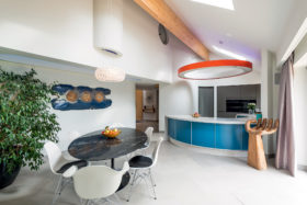 Contemporary kitchen with curved counter and circular overhead lighting