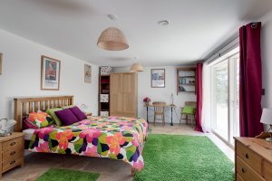 Colourful bedroom scheme with glass sliding doors