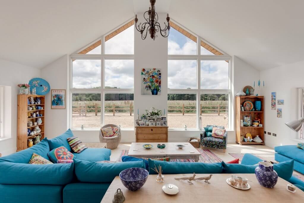 Contemporary living space with vast windows in gables