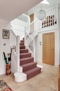White wood staircase with carpet tread
