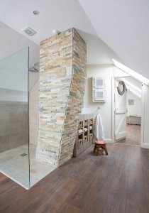 Bathroom with crooked stone chimney breast