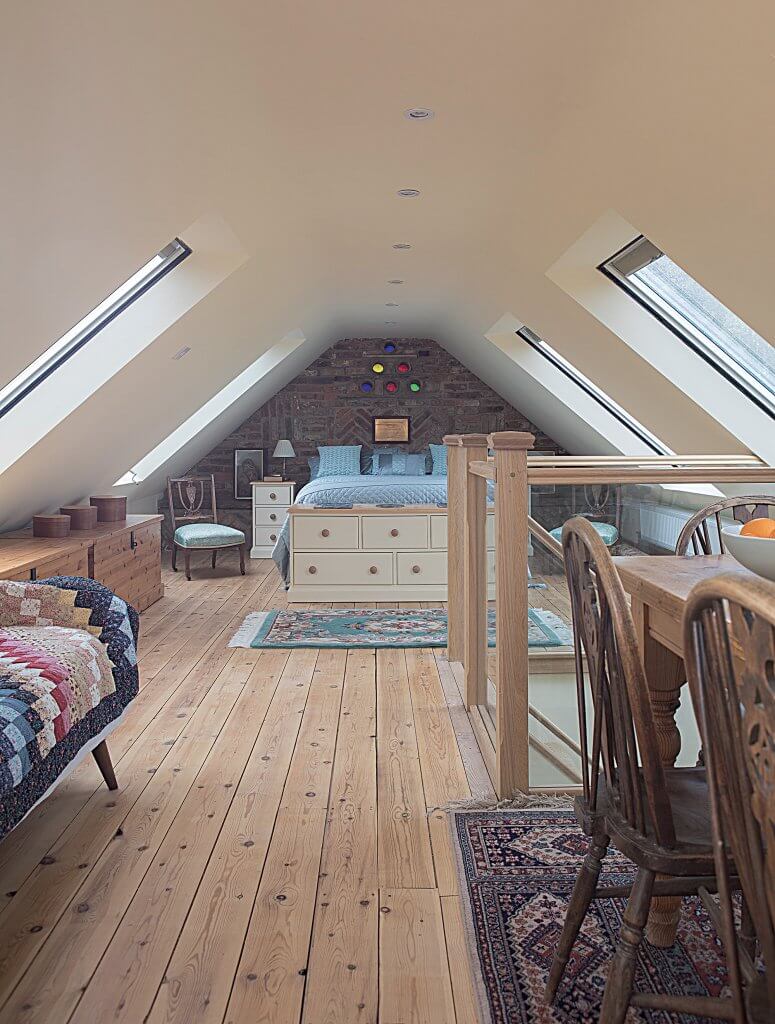 Rustic loft bedroom with exposed brick wall