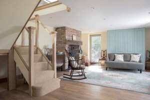 Open-plan lounge with wood staircase